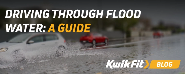 A car driving through flood water.